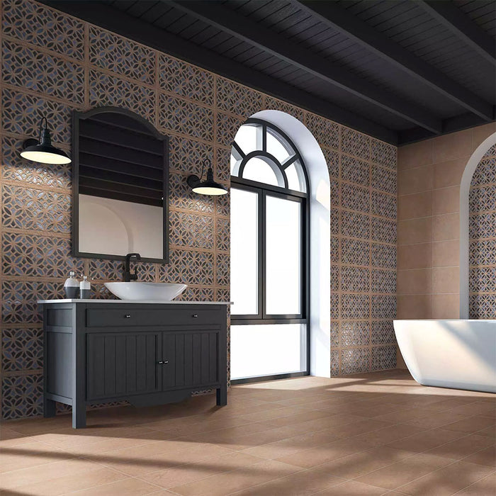 Bathroom featuring Ourika Azure Blue Moroccan style decorative porcelain wall tiles, showcasing an intricate geometric floral pattern in rich blue, charcoal, beige and cream tones, paired with warm terracotta floor tiles, black vanity furniture, arched windows and contemporary fixtures for a striking Moroccan-inspired interior.
