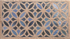 Close-up of Ourika Azure Blue Moroccan style decorative porcelain wall tile, featuring an intricate interlocking geometric floral pattern in rich azure