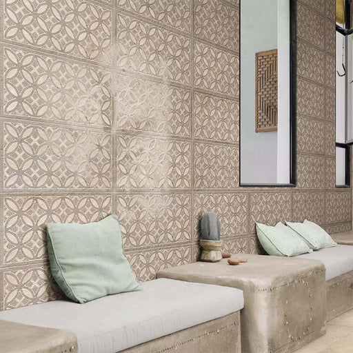Bathroom featuring Ourika Sandy Beach Moroccan style decorative porcelain wall tiles, showcasing an intricate geometric floral pattern in soft sand, taupe and warm beige tones with a gently aged finish, paired with built-in concrete seating, pale green cushions, black framed mirrors and natural textures for a calm, contemporary Moroccan-inspired interior.