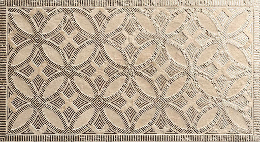 Close-up of Ourika Sandy Beach Moroccan style decorative porcelain wall tile, featuring an intricate carved geometric floral pattern in soft sandy beige and taupe tones with textured engraved detailing and a gently aged finish, perfect for creating statement bathroom walls, kitchen splashbacks and feature walls with timeless Moroccan-inspired character.