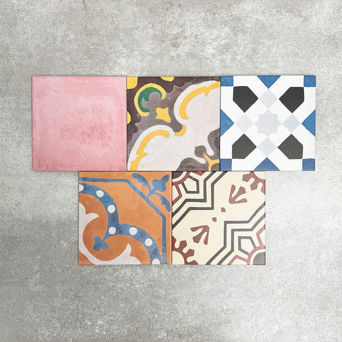 Fayrouz Patchwork 20×20cm Moroccan-style porcelain tiles arranged in a colourful patchwork mix of geometric and floral patterns, featuring rich tones of blue, green, pink and warm neutrals.