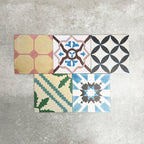Fayrouz Patchwork 20×20cm Moroccan-style porcelain tiles arranged in a colourful patchwork mix of geometric and floral patterns, featuring rich tones of blue, green, pink and warm neutrals.