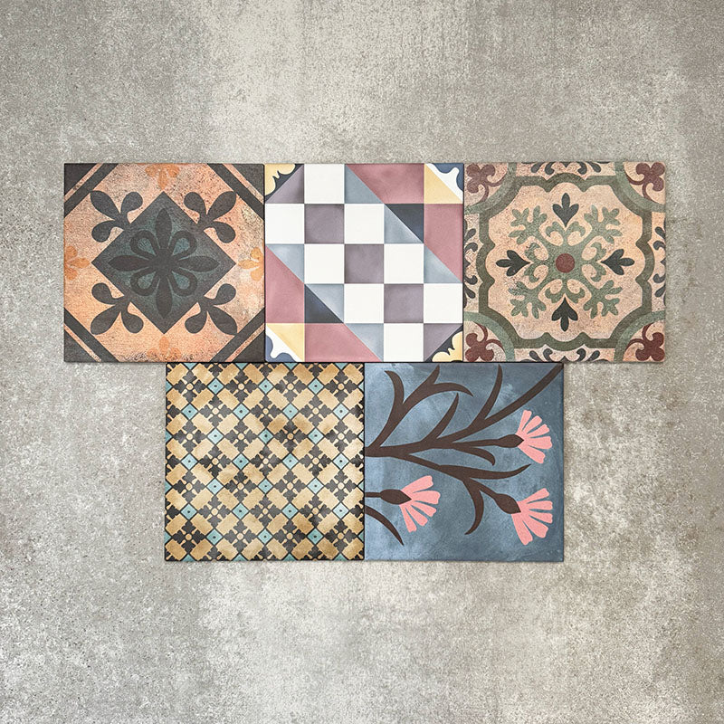 Cuba Patchwork Moroccan-style porcelain tiles in a 20×20cm square format, arranged in a mixed patchwork layout featuring a variety of geometric, floral and traditional motifs in earthy, green, blue and terracotta tones, highlighting the tile’s eclectic, encaustic-style design and rich visual texture.