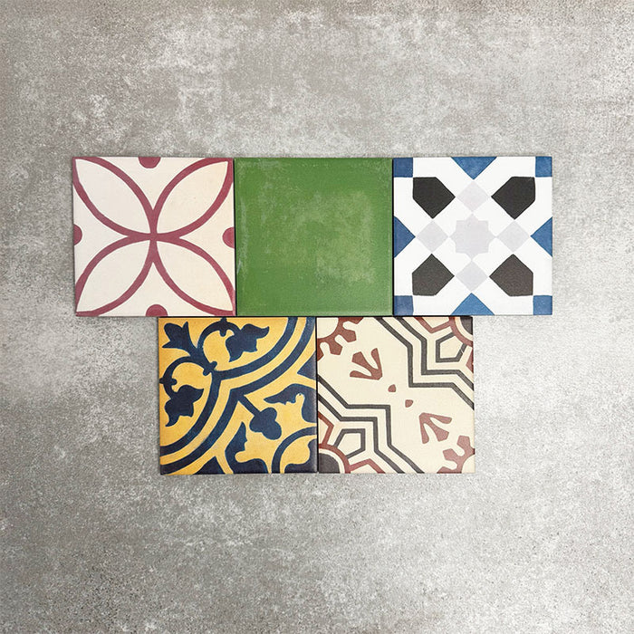 Fayrouz Mini Patchwork 15×15cm Moroccan-style porcelain tiles displayed as a mixed patchwork layout, showcasing a vibrant collection of geometric and floral designs in green, blue, pink, mustard, terracotta and neutral tones.