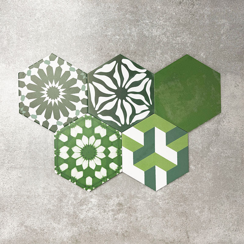 Fayrouz Verde Hexagon Patchwork Moroccan-style porcelain tiles in an 18.7 × 21.6cm hexagon format, showcasing a coordinated mix of geometric, starburst and zigzag patterns in layered green, sage, mint and charcoal tones, arranged as a decorative patchwork group to highlight colour variation and pattern diversity.