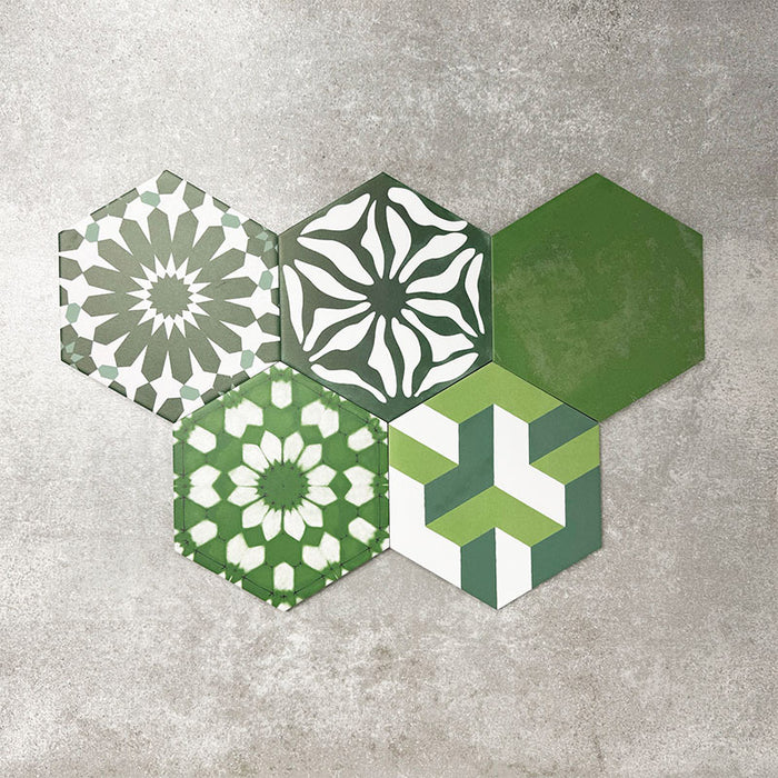 Fayrouz Verde Hexagon Patchwork Moroccan-style porcelain tiles in an 18.7 × 21.6cm hexagon format, showcasing a coordinated mix of geometric, starburst and zigzag patterns in layered green, sage, mint and charcoal tones, arranged as a decorative patchwork group to highlight colour variation and pattern diversity.