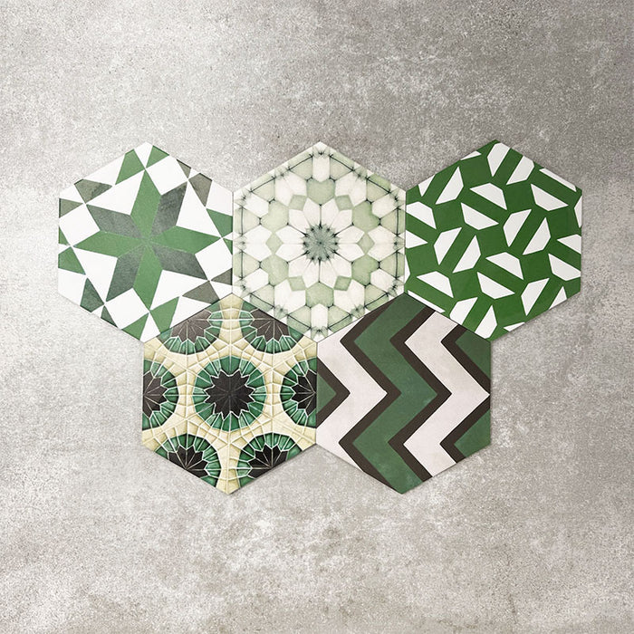 Fayrouz Verde Hexagon Patchwork Moroccan-style porcelain tiles in an 18.7 × 21.6cm hexagon format, showcasing a coordinated mix of geometric, starburst and zigzag patterns in layered green, sage, mint and charcoal tones, arranged as a decorative patchwork group to highlight colour variation and pattern diversity.