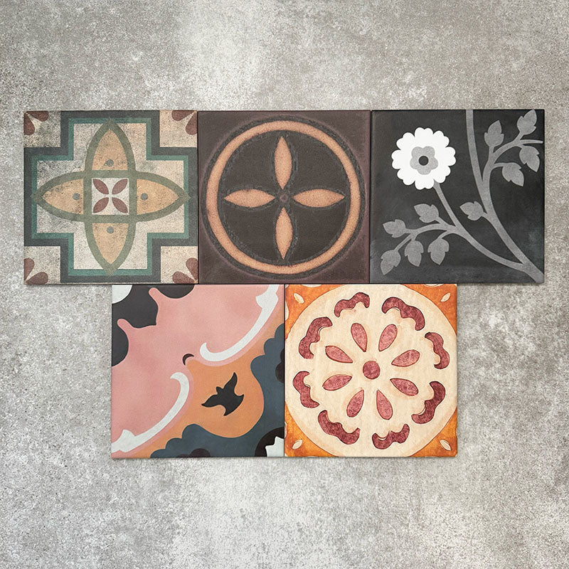 Cuba Patchwork Moroccan-style porcelain tiles in a 20×20cm square format, arranged in a mixed patchwork layout featuring a variety of geometric, floral and traditional motifs in earthy, green, blue and terracotta tones, highlighting the tile’s eclectic, encaustic-style design and rich visual texture.