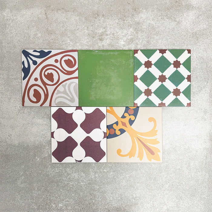 Fayrouz Patchwork 20×20cm Moroccan-style porcelain tiles arranged in a colourful patchwork mix of geometric and floral patterns, featuring rich tones of blue, green, pink and warm neutrals.