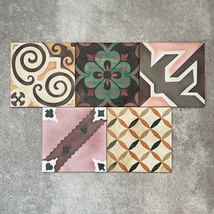 Cuba Patchwork Moroccan-style porcelain tiles in a 20×20cm square format, arranged in a mixed patchwork layout featuring a variety of geometric, floral and traditional motifs in earthy, green, blue and terracotta tones, highlighting the tile’s eclectic, encaustic-style design and rich visual texture.