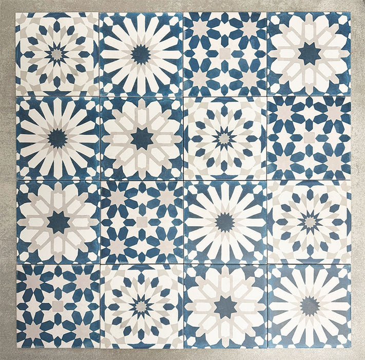 Souk Blue B 20×20cm Moroccan-style porcelain patchwork tiles featuring mixed blue, white and grey geometric patterns.