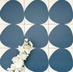 Pebbles Reversed Blue 20x20cm porcelain Moroccan-style tiles featuring bold organic blue shapes on a soft white background, designed to create playful statement walls and contemporary patterned interiors.