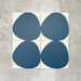 Pebbles Reversed Blue 20x20cm porcelain Moroccan-style tiles featuring bold organic blue shapes on a soft white background, designed to create playful statement walls and contemporary patterned interiors.