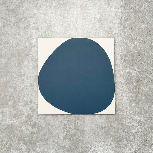 Pebbles Reversed Blue 20x20cm porcelain Moroccan-style tiles featuring bold abstract blue shapes on a soft white background, designed to create playful statement walls and contemporary patterned interiors.