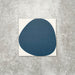 Pebbles Reversed Blue 20x20cm porcelain Moroccan-style tiles featuring bold abstract blue shapes on a soft white background, designed to create playful statement walls and contemporary patterned interiors.