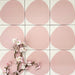 Pebbles Reversed Pink 20x20cm porcelain Moroccan-style tiles featuring soft blush abstract shapes on a warm white background, designed to create playful statement walls and contemporary patterned interiors.