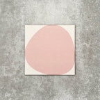 Pebbles Reversed Pink 20x20cm porcelain Moroccan-style tiles featuring soft blush abstract shapes on a warm white background, designed to create playful statement walls and contemporary patterned interiors.