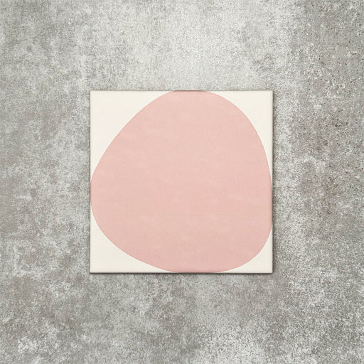 Pebbles Reversed Pink 20x20cm porcelain Moroccan-style tiles featuring soft blush abstract shapes on a warm white background, designed to create playful statement walls and contemporary patterned interiors.