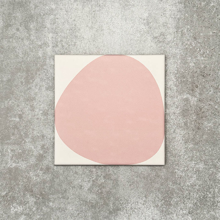 Pebbles Reversed Pink 20x20cm porcelain Moroccan-style tiles featuring soft blush abstract shapes on a warm white background, designed to create playful statement walls and contemporary patterned interiors.