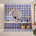 Bathroom featuring Peniscola Blue and Yellow patterned wall and floor tiles, showcasing a bold Mediterranean-inspired floral geometric design in vibrant cobalt blue, warm yellow and crisp white tones, paired with a floating stone vanity, round mirror, woven pendant lights, natural baskets and soft neutral finishes for a bright, characterful interior.
