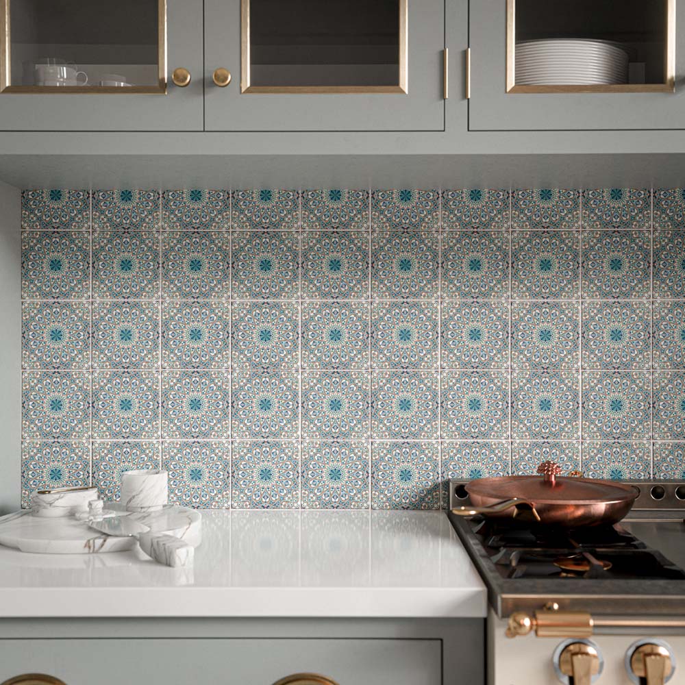 Persia Kashan MINI 15cm x 15cm Moroccan style tiles, showcasing an intricate repeating geometric pattern in blue, turquoise and warm neutral tones across the kitchen splashback, paired with soft grey cabinetry and brass details.