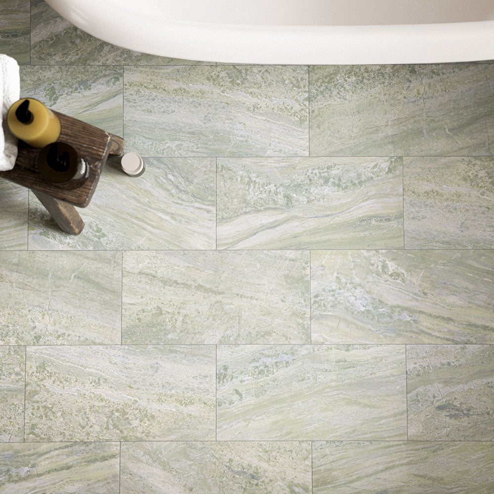 Petra Verde Green 30cm x 60cm stone marble effect tiles, featuring soft green and cream tones with natural-looking veining and tonal variation across the bathroom floor.