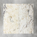 Close-up of Fayrouz Picasso natural marble tiles in a honed finish, 30.5x61cm format, showcasing a soft white base with warm beige undertones and distinctive veining, creating a refined and elegant look for wall and floor applications.