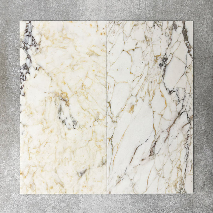 Close-up of Fayrouz Picasso natural marble tiles in a honed finish, 30.5x61cm format, showcasing a soft white base with warm beige undertones and distinctive veining, creating a refined and elegant look for wall and floor applications.