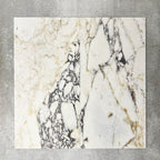 Close-up of Fayrouz Picasso natural marble tiles in a honed finish, 30.5x61cm format, showcasing a soft white base with warm beige undertones and distinctive veining, creating a refined and elegant look for wall and floor applications.