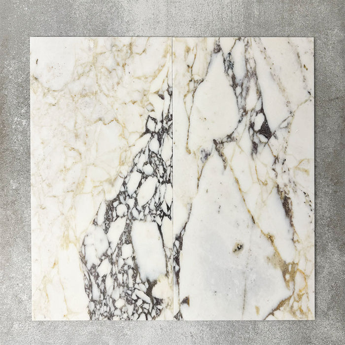 Close-up of Fayrouz Picasso natural marble tiles in a honed finish, 30.5x61cm format, showcasing a soft white base with warm beige undertones and distinctive veining, creating a refined and elegant look for wall and floor applications.