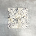 Arrangement featuring Fayrouz Picasso 5x20cm natural marble tiles with a honed finish, laid in a basketweave pattern to create visual texture and structure, showcasing a white base with bold grey, green and warm gold veining and natural variation across each piece.