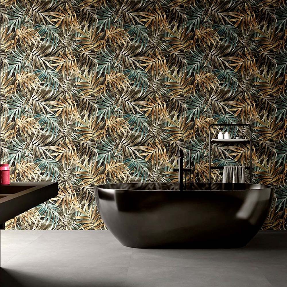 Bathroom featuring Plant Life Dark Decor 60x120cm botanical-style wall tiles, showcasing an oversized tropical leaf design in deep green, bronze and neutral tones, paired with a freestanding black bath, black fittings and large grey floor tiles.