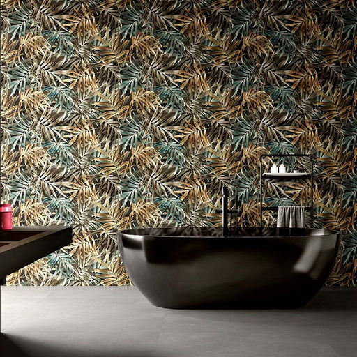 Bathroom featuring Plant Life Dark Decor 60x120cm botanical-style wall tiles, showcasing an oversized tropical leaf design in deep green, bronze and neutral tones, paired with a freestanding black bath, black fittings and large grey floor tiles.