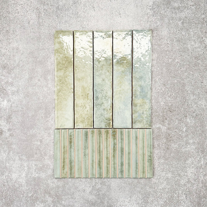 Product display of Pottery Decor Agave Green 12.5x25cm ceramic wall tiles in soft green tones, featuring a handcrafted glossy finish with coordinating fluted decorative tiles for textured contemporary interiors.