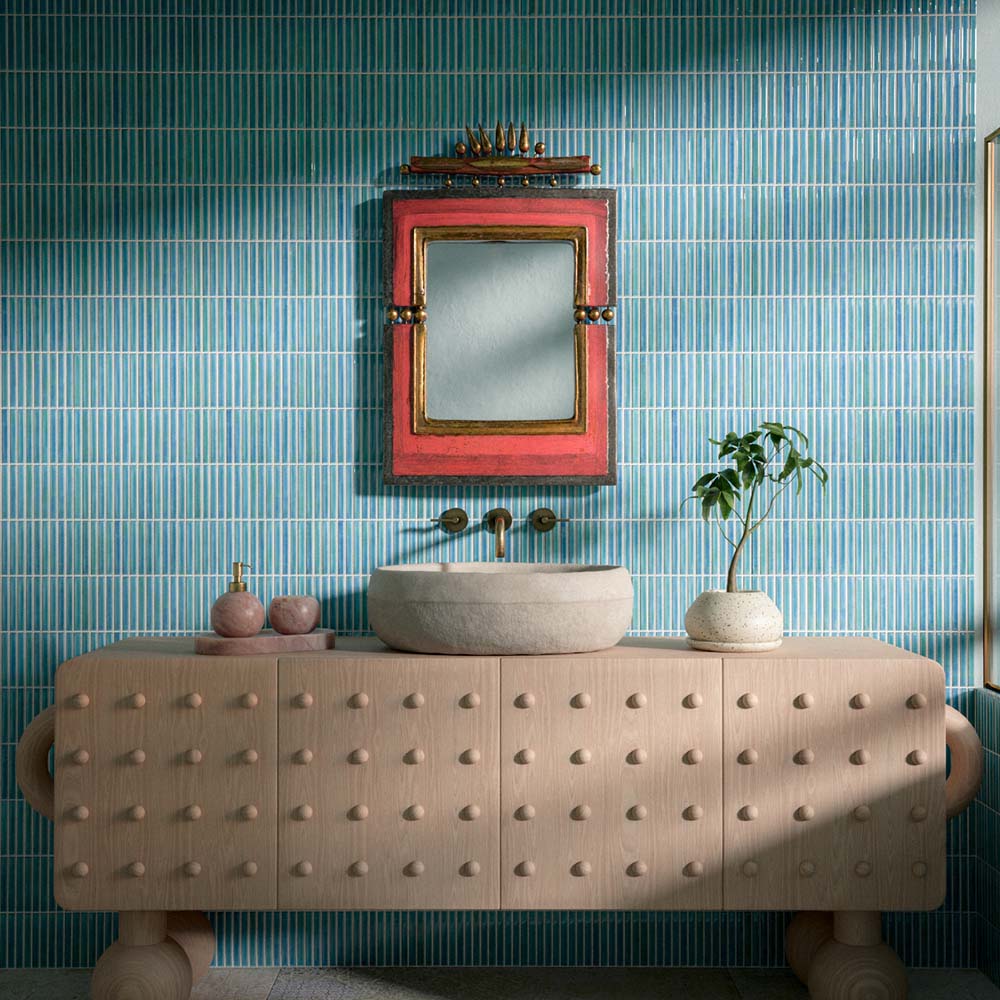 Bathroom featuring Pottery Decor Azul Blue 12.5x25cm wall tiles, styled with a sculptural wood vanity unit, stone basin, and colourful statement mirror for a playful contemporary bathroom design.