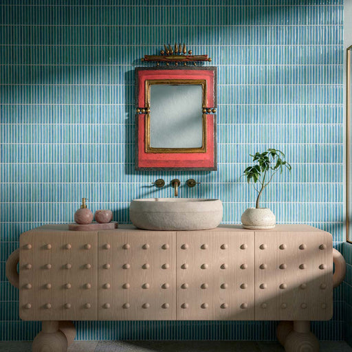 Bathroom featuring Pottery Decor Azul Blue 12.5x25cm wall tiles, styled with a sculptural wood vanity unit, stone basin, and colourful statement mirror for a playful contemporary bathroom design.