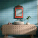 Bathroom featuring Pottery Decor Azul Blue 12.5x25cm wall tiles, styled with a sculptural wood vanity unit, stone basin, and colourful statement mirror for a playful contemporary bathroom design.