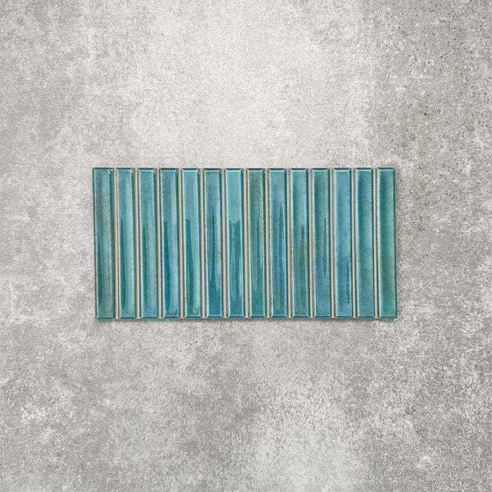 Product display of Pottery Decor Azul Blue 12.5x25cm ceramic wall tiles in vibrant blue tones, featuring a linear fluted design, handcrafted glossy finish and subtle tonal variation for textured contemporary interiors.