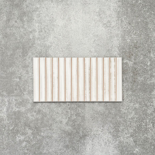 Product display of Pottery Decor Blanco 12.5x25cm ceramic wall tiles in soft white tones, featuring a linear fluted design, handcrafted glossy finish and subtle tonal variation for textured contemporary interiors.