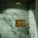 Walk-in shower featuring Pottery Decor Forest Green 12.5 × 25cm ceramic wall tiles, showcasing a rich glossy green finish with a vertically lined textured surface, paired with brass shower fittings and a recessed niche for a refined spa-inspired look.