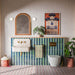 Pottery Prussian Brick 5cm x 25cm wall tiles, featuring rich blue tones across the bathroom walls, laid vertically and combined with green tiles, patterned flooring, neutral finishes and warm brass details.