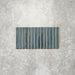 Product display of Pottery Decor Prussian 12.5x25cm ceramic wall tiles in deep blue tones, featuring a linear fluted design, handcrafted glossy finish and subtle tonal variation for textured contemporary interiors.