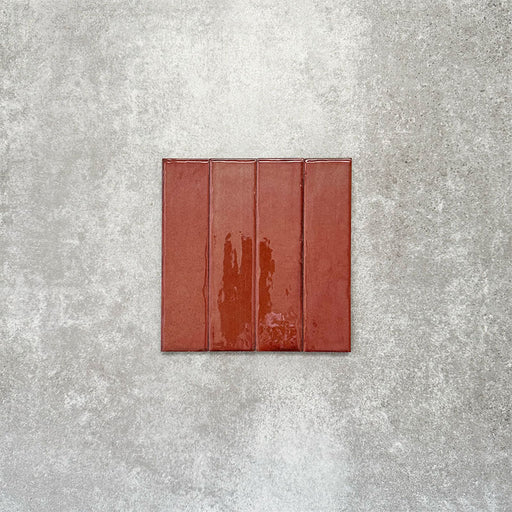 Product image of Puzzle Coral Brick Rectified 5x20cm wall and floor tiles, featuring a glossy coral finish with rich tonal variation and softly aged edges, displayed to highlight the tile's handcrafted character.