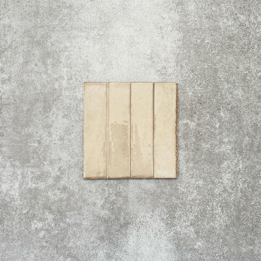 Product image of Puzzle Cream Brick Rectified 5x20cm wall and floor tiles, featuring a glossy cream finish with subtle shade variation and softly aged edges, displayed to highlight the tile's handcrafted character.