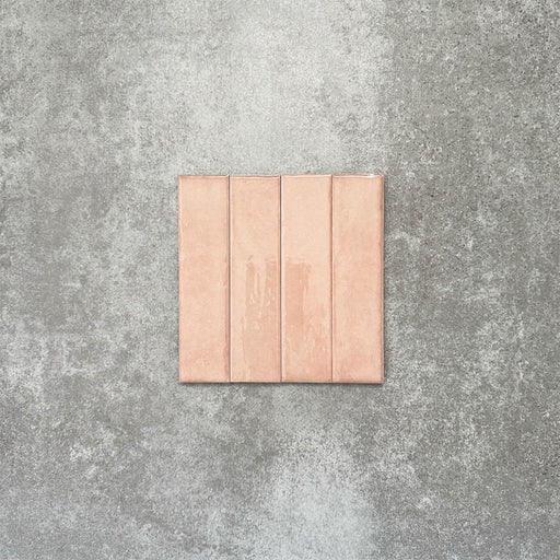 Product image of Puzzle Rose Brick Rectified 5x20cm wall and floor tiles, featuring a glossy blush pink finish with soft tonal variation and gently aged edges, displayed to highlight the tile's handcrafted character.