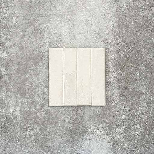 Product image of Puzzle White Brick Rectified 5x20cm wall and floor tiles, featuring a glossy white finish with subtle tonal variation, displayed in a brick format to showcase the tile's handcrafted appearance.