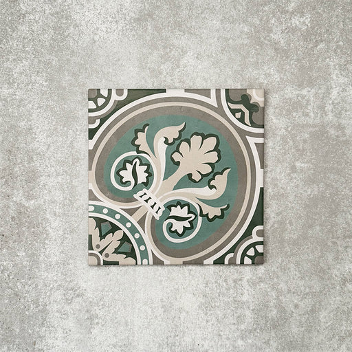 Single London Streets Regent Street 20x20cm Victorian Moroccan style porcelain tile displayed in a product setting, featuring a decorative floral-inspired geometric pattern in green, sage and cream tones inspired by traditional Victorian style floor tiles.