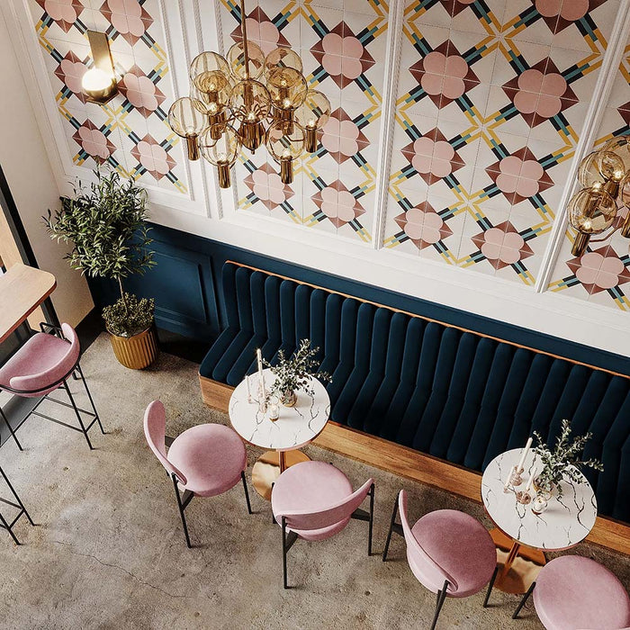 Restaurant interior featuring Abstract Contori Patterned Tiles in a 20x20cm format, installed as decorative wall panels. The elegant geometric pattern combines soft blush pink, warm neutrals and muted green accents, paired with velvet seating, marble tables and brass lighting to create a refined, contemporary dining space.