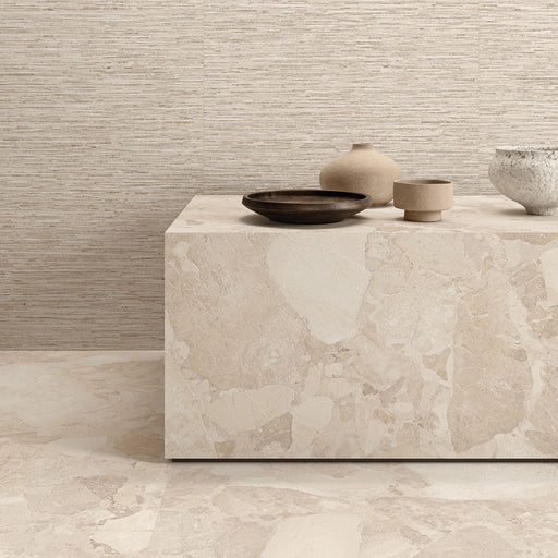 Interior featuring Riad Avorio Sassi Terrazzo Stone 60x60cm stone-effect wall and floor tiles, showcasing warm ivory and beige tones with natural stone-inspired detailing, styled with matching tiled cabinetry and light wood shelving for a contemporary finish.