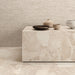 Interior featuring Riad Avorio Sassi Terrazzo Stone 60x60cm stone-effect wall and floor tiles, showcasing warm ivory and beige tones with natural stone-inspired detailing, styled with matching tiled cabinetry and light wood shelving for a contemporary finish.